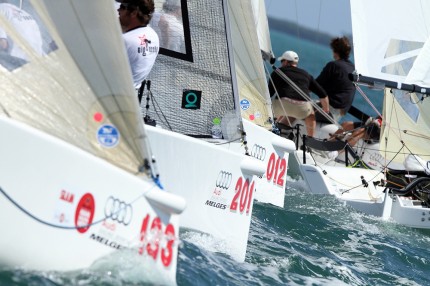 The Melges 20 fleet in tight quarters around the first top mark.